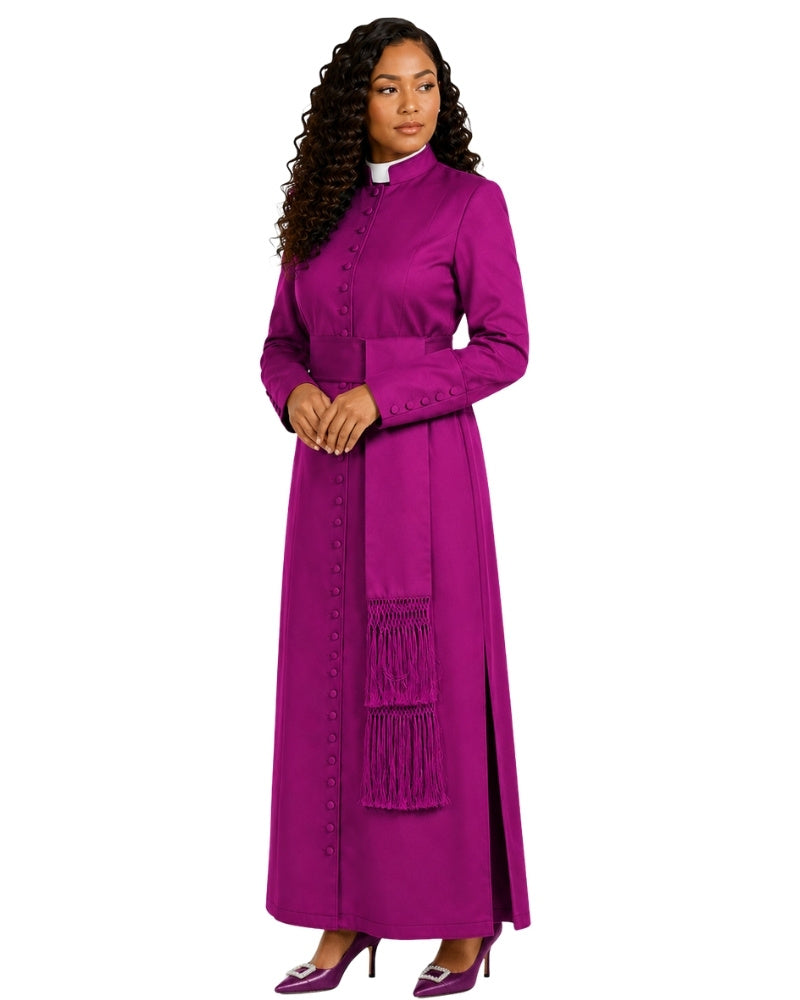 A woman modeling a long magenta-purple clerical cassock with a white collar, buttoned front, and fringe details, set against a plain white background.