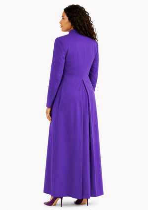 Woman wearing a purple robe on a white background