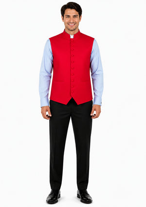Man wearing a red vest over a light blue shirt with black pants on a white background