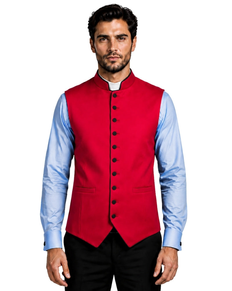 A man wearing a bright red waistcoat vest over a light blue dress shirt and black trousers, photographed against a white background.