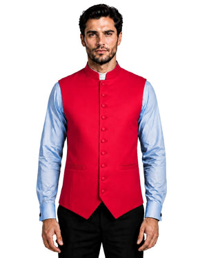 A man wearing a bright red mandarin-collar waistcoat vest over a light blue dress shirt and black trousers, photographed against a plain white background.