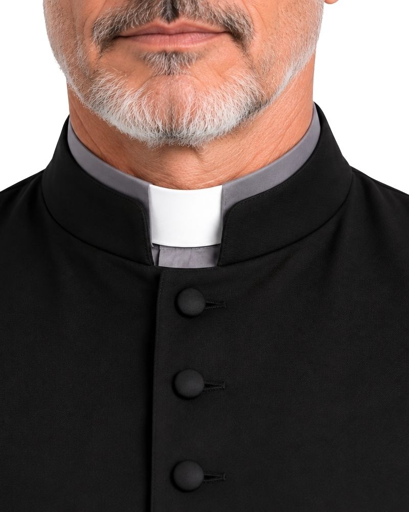 Close-up of a man wearing a Black Jedidiah Sleeveless Clergy Robe over a gray long-sleeve clerical shirt, shown against a plain white background.