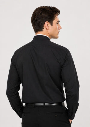 Man wearing a black dress shirt and pants on a white background