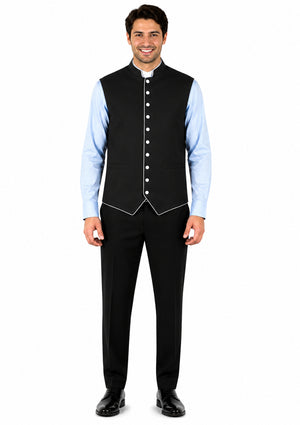 Man wearing a black vest over a light blue shirt on a white background
