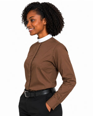 A woman with curly black hair is shown in profile wearing a brown long-sleeve clerical shirt with a white collar, paired with black trousers and a black belt, against a plain white background.