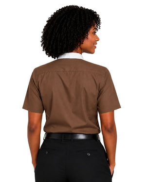 A woman shown from the back wearing a brown short-sleeve clerical shirt over a white clerical shirt, paired with black pants and a black belt, against a plain white background.