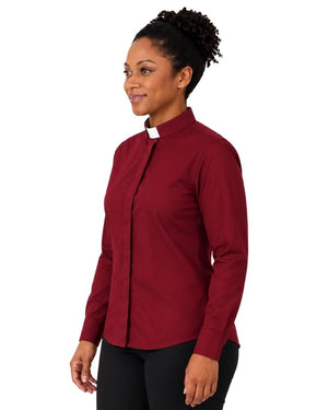 A woman wearing a long-sleeve burgundy clerical shirt with a contrasting white collar, paired with black trousers and a black belt, shown in a side-profile view against a plain white background.