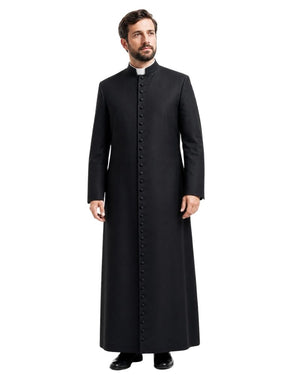 A man modeling a long black clerical cassock with a high stand collar, front button placket, and a white clerical collar, set against a plain white background.