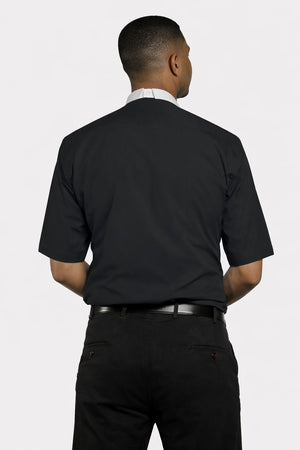 Man wearing a black dress shirt and pants on a white background