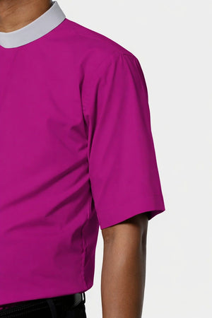 Close-up of a person wearing a Purple shirt with a white collar on a light gray background