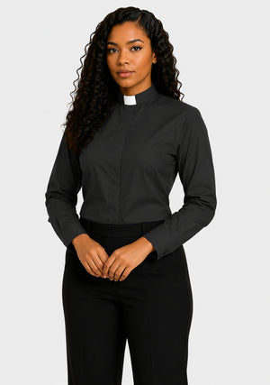 Woman wearing a black clergy shirt with a white collar on a plain background