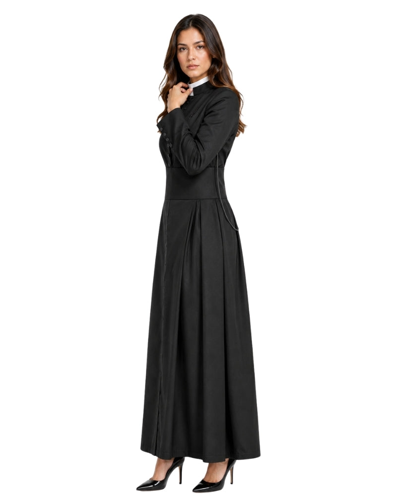 A woman modeling a long black cassock or robe with long sleeves, a high collar, and a pleated skirt, paired with black high heels, against a plain white background.