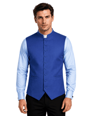 A man wearing a royal blue waistcoat vest over a light blue dress shirt, standing against a white background.