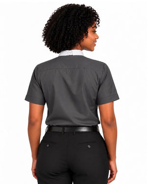 A woman shown from the back wearing a dark gray short-sleeve clerical shirt tucked into black pants with a black belt, against a plain white background.