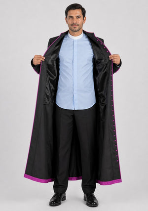 Man wearing a long black coat with purple trim on a white background