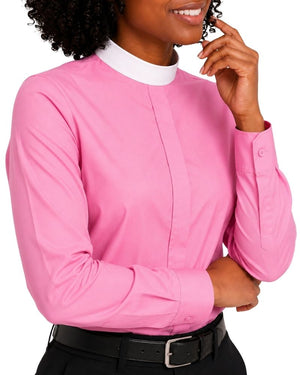 A woman wearing a bright pink long-sleeve clerical shirt with a white mock neck collar, paired with a black belt and black pants, against a plain white background.