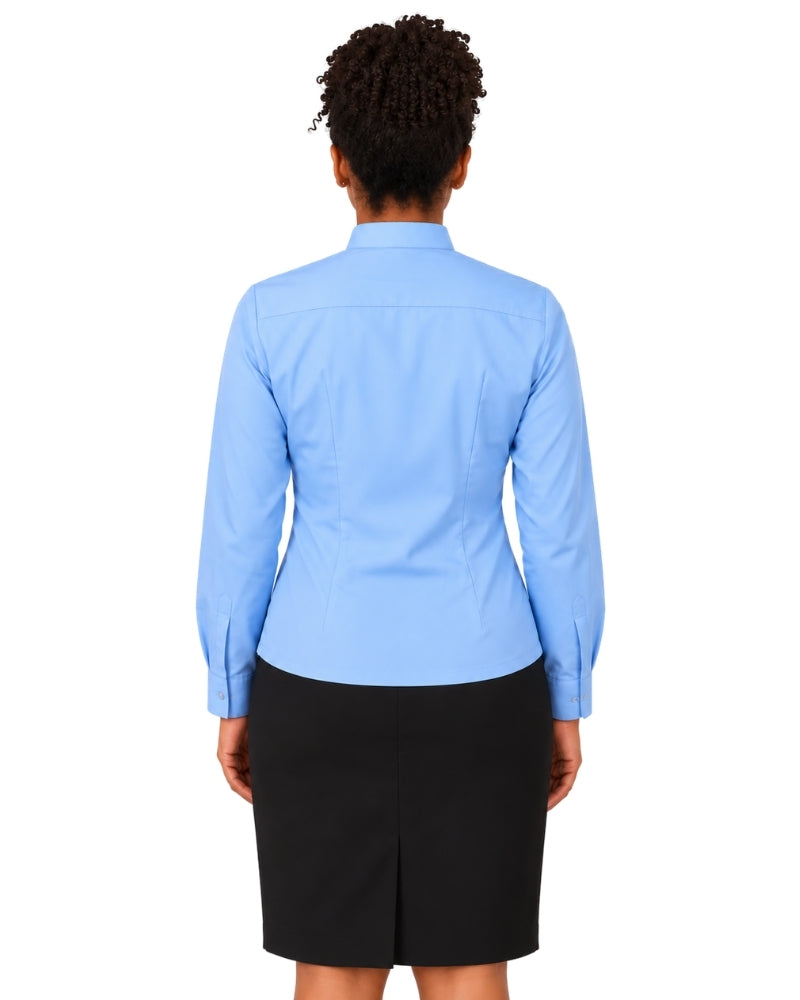 A woman shown from the back wearing a light blue long-sleeve clerical shirt and a black skirt, photographed against a plain white background.