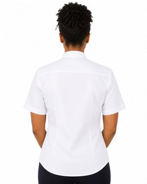 A woman viewed from the back wearing a white short-sleeve collared clerical shirt and black bottoms, against a plain white studio background.