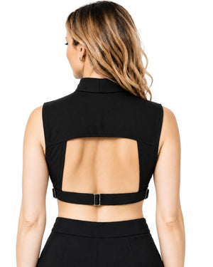 Rear view of a woman wearing a black sleeveless clergy dickey and a wide back cutout secured by a thin strap with a small metal buckle, paired with black bottoms, on a white background.