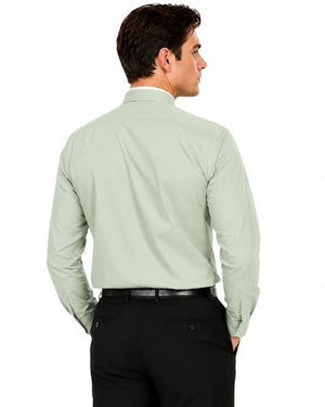 A man shown from the back wearing a light sage green long-sleeve clerical shirt and black trousers, photographed against a plain white studio background.