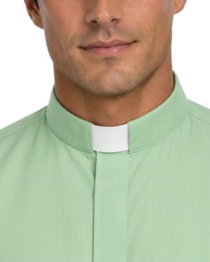 A close-up of a man wearing a light green clerical shirt with a white collar tab, shown from the lower face to the chest against a plain white background.