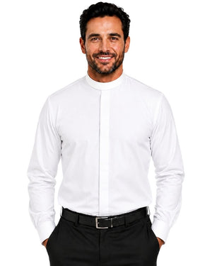 A smiling man wearing a white long-sleeve clerical shirt with a high mock neck and a central pleat detail, paired with black trousers and a black belt, against a plain white background.