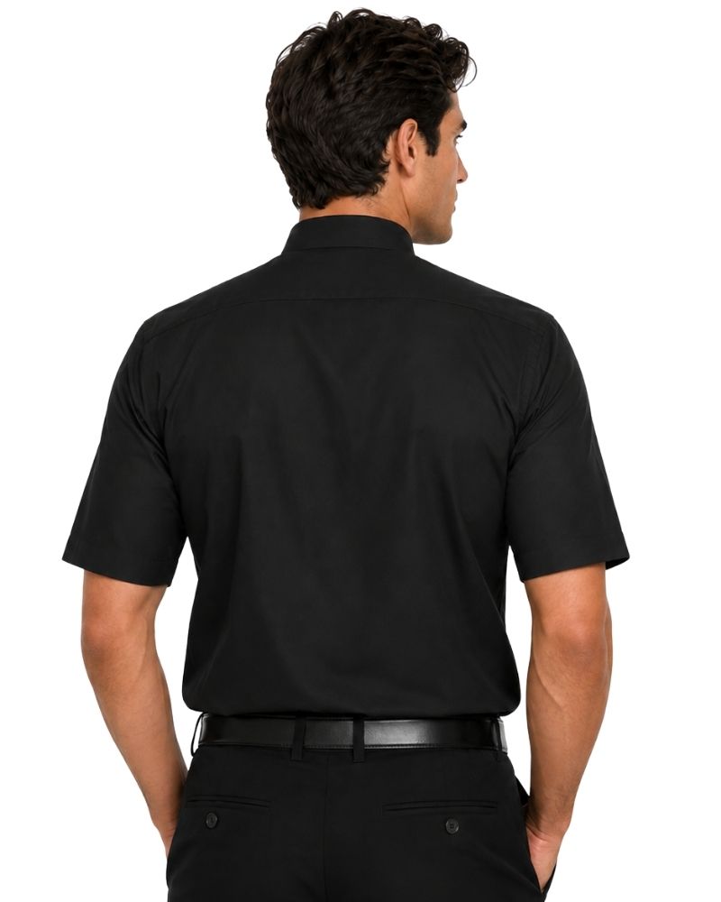 A man viewed from the back wearing a black short-sleeve button-up shirt and black trousers against a plain white background.