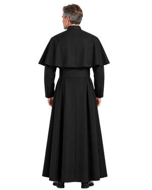 A man viewed from the back wearing a long black clerical robe with a wide cape collar and long sleeves, standing against a plain white studio background.