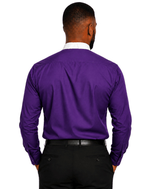 A man viewed from the back wearing a vibrant purple long-sleeve clerical shirt, black trousers, and a white collared shirt underneath, set against a plain white background.