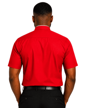 A man viewed from the back wearing a bright red short-sleeve clerical shirt and black trousers against a plain white background.
