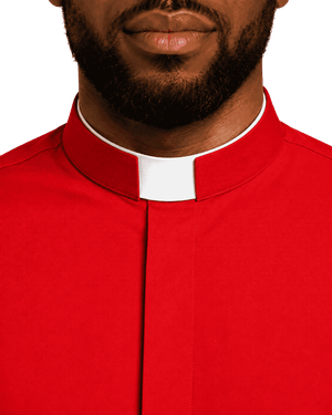 A close-up of a man wearing a bright red clerical collar shirt with a white collar tab, cropped from the lower face to the chest against a plain white background.