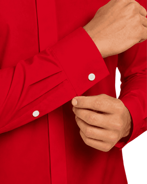 Close-up of a person wearing a bright red long-sleeve clerical shirt with white buttons, adjusting the cuff with one hand while the other hand rests near the collar area.