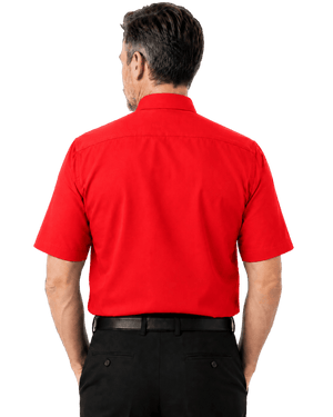 A man viewed from the back wearing a bright red short-sleeve clerical shirt and black trousers, isolated on a solid black background.