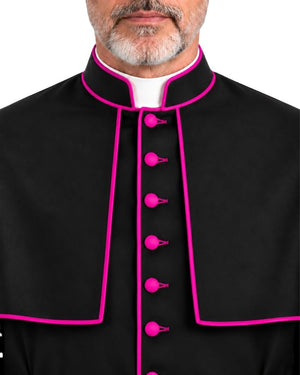 A close-up of a man wearing a Traditional Clerical Cassock With Magenta Trim with bright pink piping and matching pink buttons, over a white collar, against a plain white background.