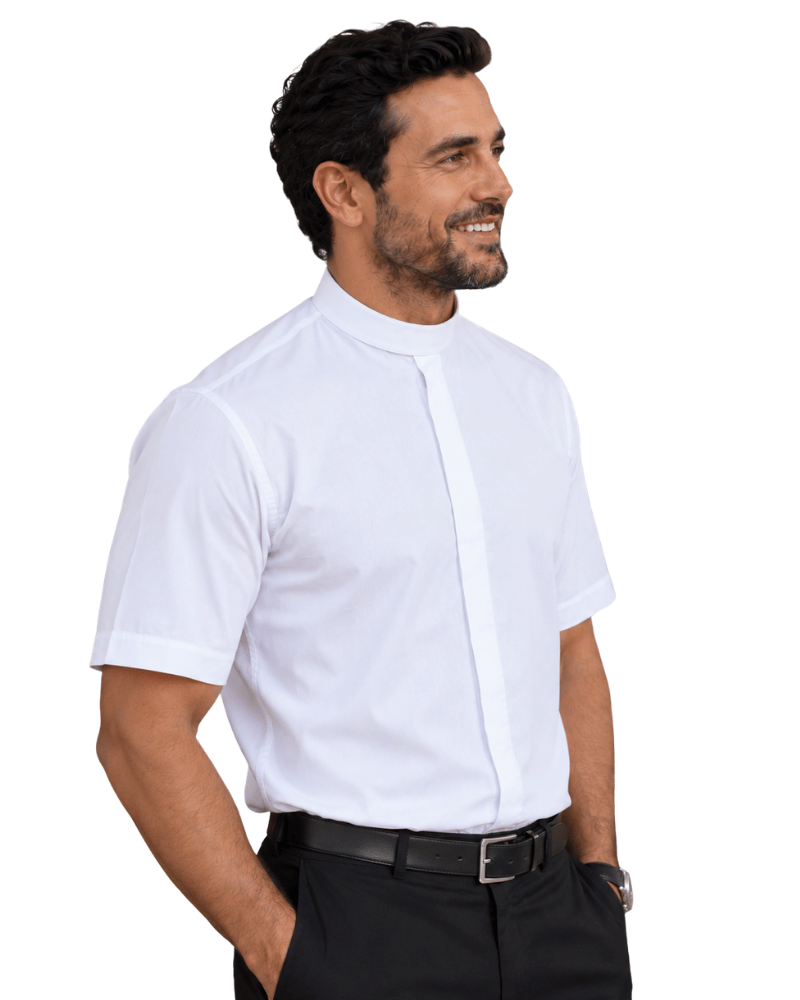 A man wearing a white short-sleeve clerical shirt with a high mock neck collar, paired with black trousers and a black belt, photographed against a solid white background.