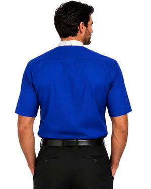 A man viewed from the back wearing a bright royal blue short-sleeve clerical shirt tucked into black dress pants with a black belt, against a plain white background.