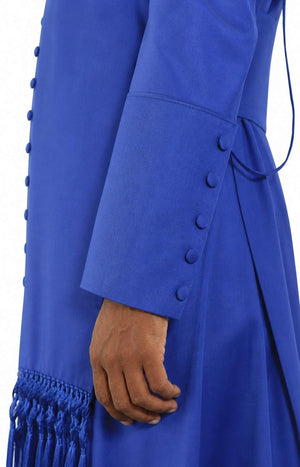 Close-up of a blue garment with buttons and fringes on a white background