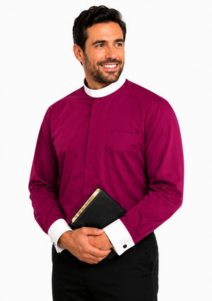 Man wearing a magenta shirt with a white collar holding a black book on a white background