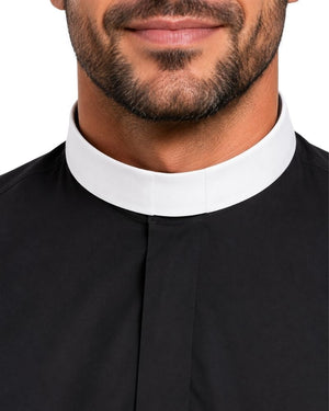 Close-up of a man wearing a black clerical shirt with a contrasting white collar, shown against a plain white background.