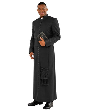A man modeling a long black clerical robe with a high collar, front buttons, and a matching black fringed scarf, holding a small book against a plain white background.