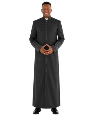 A man modeling a long-sleeved black clerical robe with a button-down front and a white collar, standing against a plain white background.