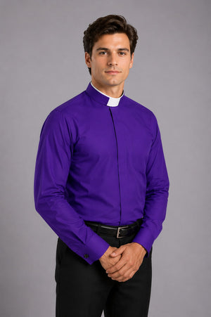 Man wearing a purple shirt with a clerical collar against a gray background