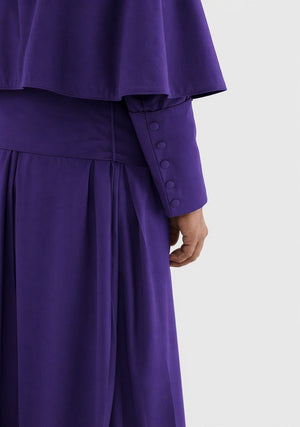 Purple outfit with a close-up of the sleeve and waistband on a white background
