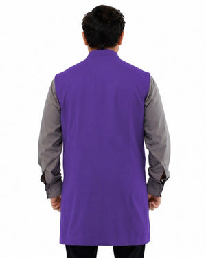 Man wearing a purple vest over a gray shirt on a white background