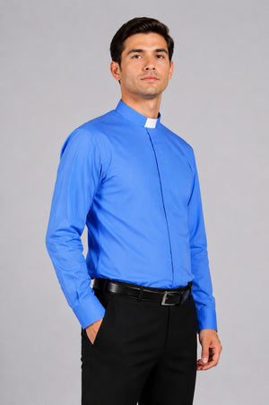 Man wearing a blue clerical shirt with a white collar against a gray background
