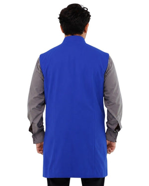 Man wearing a blue vest over a gray shirt on a white background