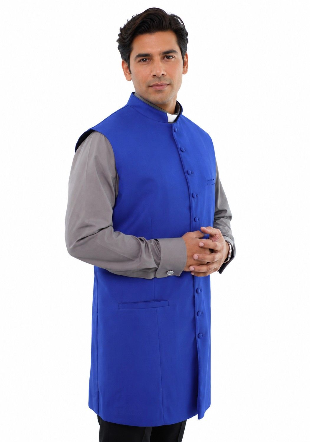 Man wearing a blue vest over a gray shirt on a white background
