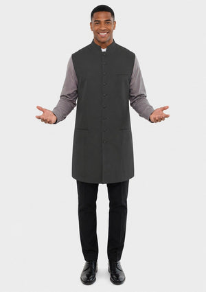 Man wearing a gray vest over a long-sleeve shirt on a white background
