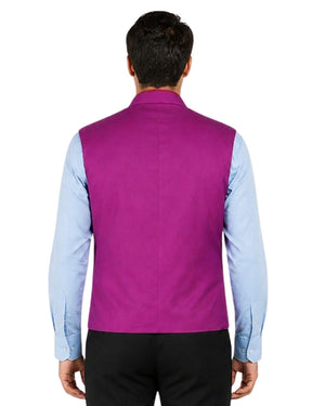 Man wearing a purple vest with red trim with re trim over a light blue shirt on a white background.