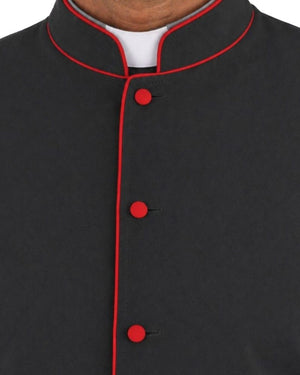 Close-up of a black mandarin collar cassock with red piping and red buttons, worn over a white undershirt.